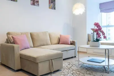 a living room with a couch and a table at 1BHK in central of Dubai Marina in Dubai