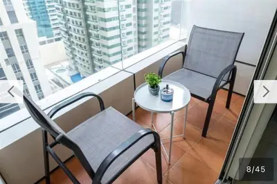 a balcony with two chairs and a table and a window at 1BHK in central of Dubai Marina in Dubai