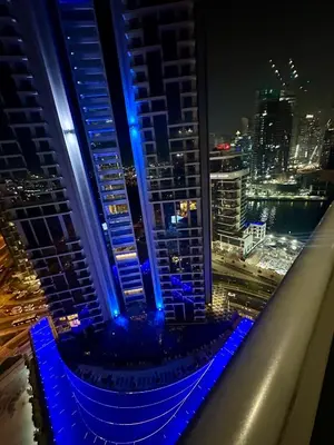 a view from the top of a building at night at Elite Residence business bay Downtown Dubai in Dubai