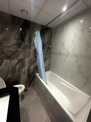 a bathroom with a tub and a toilet and a shower curtain at Elite Residence business bay Downtown Dubai in Dubai