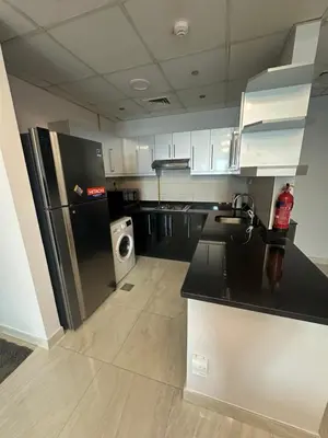 a kitchen with a refrigerator and a washer and dryer at Elite Residence business bay Downtown Dubai in Dubai