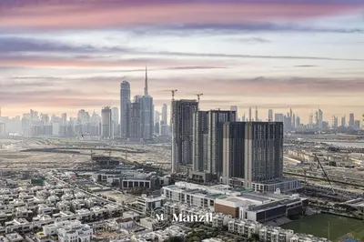 an aerial view of a city with tall buildings at 1BR Apartment in Sobha Hartland with Skyline Views in Dubai