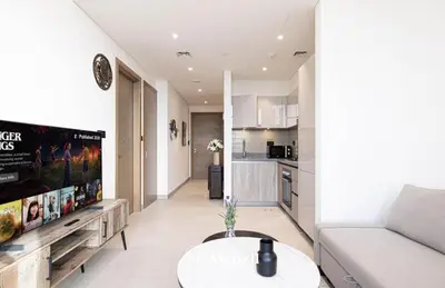 a living room with a couch and a table at 1BR Apartment in Sobha Hartland with Skyline Views in Dubai