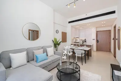 a living room with a couch and a table at Sky-High Serenity - Stylish 1BHK - 20th Floor in Dubai