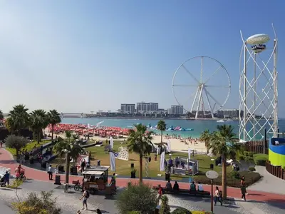 a amusement park with a ferris wheel and a beach at Damac Waves Tower Dubai Marina - By Home Of Choice in Dubai