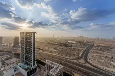an aerial view of a city with a tall building at Chic 1-Bedroom in Binghatti House JVC in Dubai