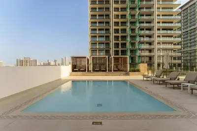 a large swimming pool on the roof of a building at Chic 1-Bedroom in Binghatti House JVC in Dubai
