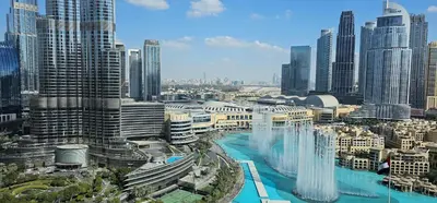 a view of a city with tall buildings and waterfalls at GRANDE SIGNATURE- 2BR Apartment with full Burj Khalifa views in Dubai