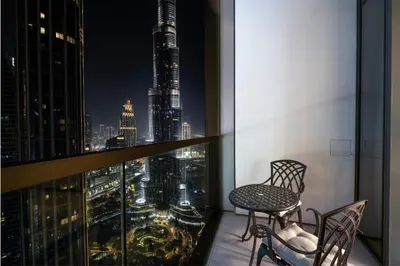 a balcony with a view of a city skyline at night at GRANDE SIGNATURE- 2BR Apartment with full Burj Khalifa views in Dubai