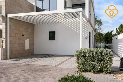 a white pergola on the side of a house at Keysplease 4BR, Nanny room, BBQ, Garden, Malibu Beach Access, Damac Hills in Dubai