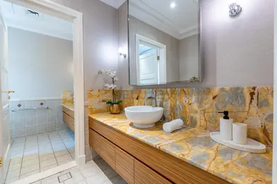 a bathroom with a sink and a mirror at Exclusive Beachfront Villa with Private Beach Access, Next to the Community Pool, Close to Aquaventure Waterpark, Monorail, and Nakheel Mall, Canal Cove, Palm Jumeirah by Deluxe Holiday Homes in Dubai