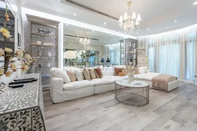 a living room with a white couch and a table at Exclusive Beachfront Villa with Private Beach Access, Next to the Community Pool, Close to Aquaventure Waterpark, Monorail, and Nakheel Mall, Canal Cove, Palm Jumeirah by Deluxe Holiday Homes in Dubai