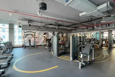 a gym with treadmills and machines in a room at GuestReady - Exquisite living with Marina views in Dubai