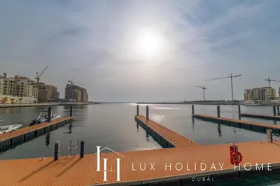 a marina with a dock in the water with buildings at LUX The La Mer Infinity View - Luxury Boho Suite 1 in Dubai