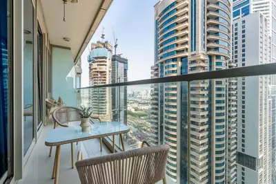 a balcony with a table and chairs and tall buildings at GuestReady - Contemporary living in Dubai Marina in Dubai