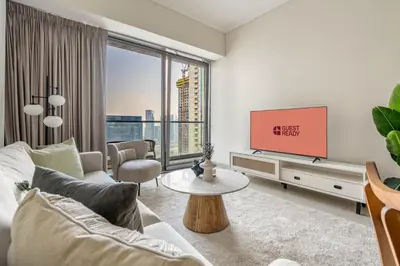 a living room with a couch and a tv at GuestReady - Contemporary living in Dubai Marina in Dubai