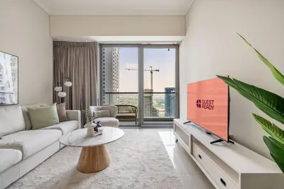 a living room with a couch and a tv at GuestReady - Contemporary living in Dubai Marina in Dubai