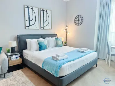 a bedroom with a large bed with towels on it at Modern Studio in Business Bay Capital Bay Tower in Dubai