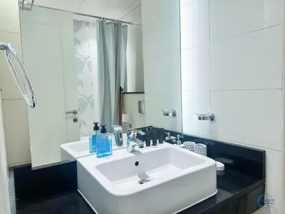 a bathroom with a white sink and a mirror at Modern Studio in Business Bay Capital Bay Tower in Dubai