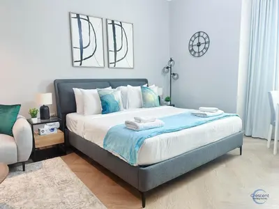 a bedroom with a bed with two towels on it at Modern Studio in Business Bay Capital Bay Tower in Dubai