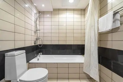a bathroom with a bath tub and a toilet at GuestReady - Downtown charm with skyline views in Dubai