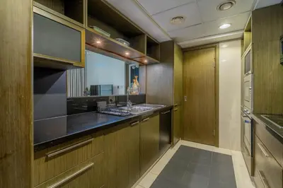 a kitchen with wooden cabinets and a sink at GuestReady - Downtown charm with skyline views in Dubai