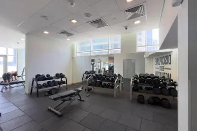a gym with treadmills and machines in a room at GuestReady - Downtown charm with skyline views in Dubai
