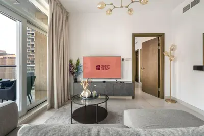 a living room with a couch and a tv at GuestReady - Downtown charm with skyline views in Dubai