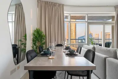 a dining room with a table with wine glasses on it at GuestReady - Downtown charm with skyline views in Dubai