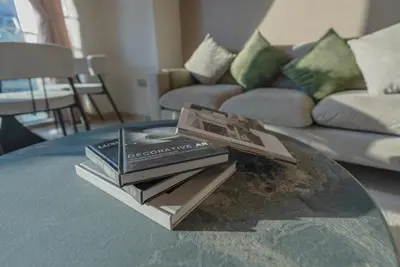 a pile of books sitting on a coffee table at Downtown Luxury - Elegant 1-Bedroom Apartment - 5 Minutes Walk to Dubai Mall in Dubai