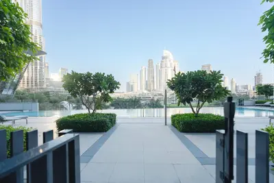 a walkway with trees and a city in the background at Downtown Luxury - Elegant 1-Bedroom Apartment - 5 Minutes Walk to Dubai Mall in Dubai