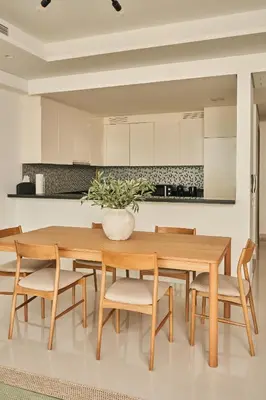 a dining room with a wooden table and chairs at Paramount - Luxury 2BR Apartments with Burj and Sea Views - Access to the Infinity Pool on 64th Floor in Dubai
