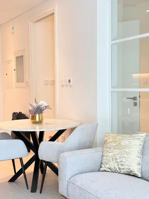 a living room with a table and a couch at One bedroom apartment brand new Dubai Hills ultra luxury furniture in Dubai