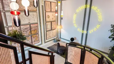 a room with a staircase with chairs and a sign at One bedroom apartment brand new Dubai Hills ultra luxury furniture in Dubai