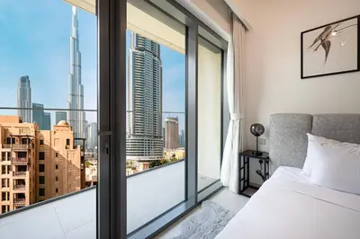 a bedroom with a bed and a large window at Full Burj Khalifa View! Brand New 2 Bedrooms! 5min walk From Dubai Mall! in Dubai