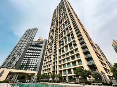 a tall building with a pool in front of it at Full Burj Khalifa View! Brand New 2 Bedrooms! 5min walk From Dubai Mall! in Dubai