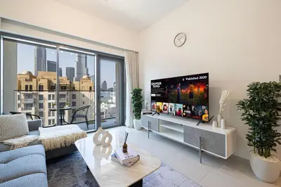a living room with a tv and a large window at Full Burj Khalifa View! Brand New 2 Bedrooms! 5min walk From Dubai Mall! in Dubai