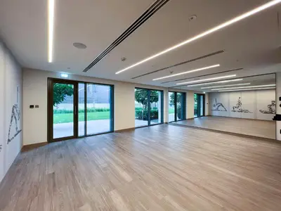 a large empty room with wooden floors and large windows at Full Burj Khalifa View! Brand New 2 Bedrooms! 5min walk From Dubai Mall! in Dubai
