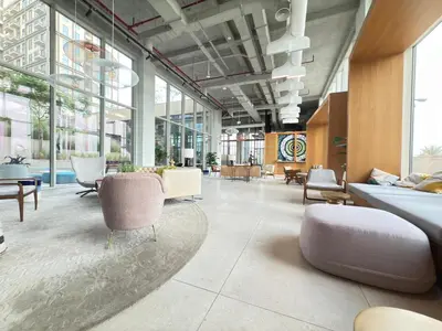 a large lobby with chairs and tables and windows at Luxe Escape at Dubai Hills in Dubai