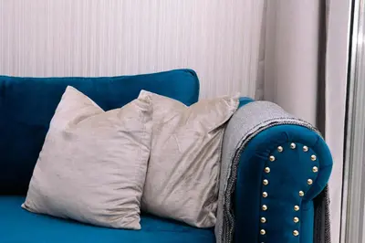 a blue couch with two pillows on it at HiGuests - Vibrant 1BR in Business Bay in Dubai