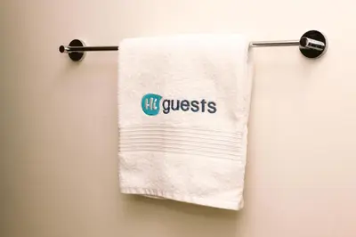 a towel with the words q questions hanging on a towel rack at HiGuests - Vibrant 1BR in Business Bay in Dubai