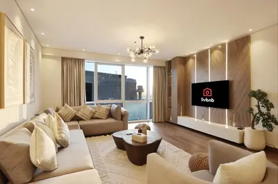 a living room with a couch and a tv at Livbnb-2B Stunner with Iconic Ain Dubai View in Dubai