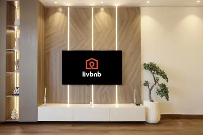 a tv on a wall in a living room at Livbnb-2B Stunner with Iconic Ain Dubai View in Dubai