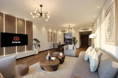 a living room with a couch and a tv at Livbnb-2B Stunner with Iconic Ain Dubai View in Dubai
