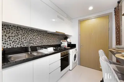 a kitchen with a sink and a dishwasher at Sky-High Aykon City Studio in Dubai