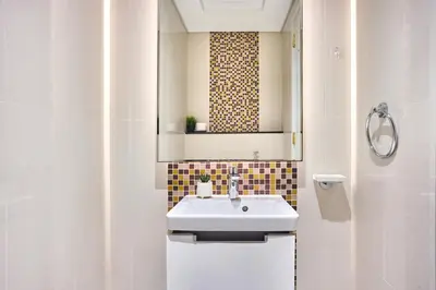 a bathroom with a sink and a mirror at Downtown 1BR - 5 minutes to mall - panoramic pool in Dubai
