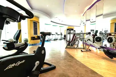 a gym with treadmills and machines in a room at Downtown 1BR - 5 minutes to mall - panoramic pool in Dubai