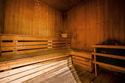 an empty wooden sauna with a plant in it at Modern Studio Apartment in Lake View in Dubai