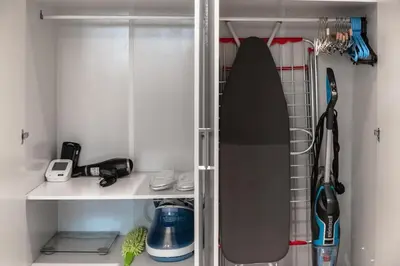 a surfboard on a shelf in a closet at Clever Guest 002 Elite Downtown in Dubai