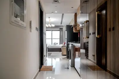a kitchen with a refrigerator and a dining room at Clever Guest 002 Elite Downtown in Dubai